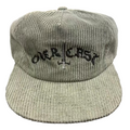 Green corduroy cap with 'ORCASA' logo on a textured surface