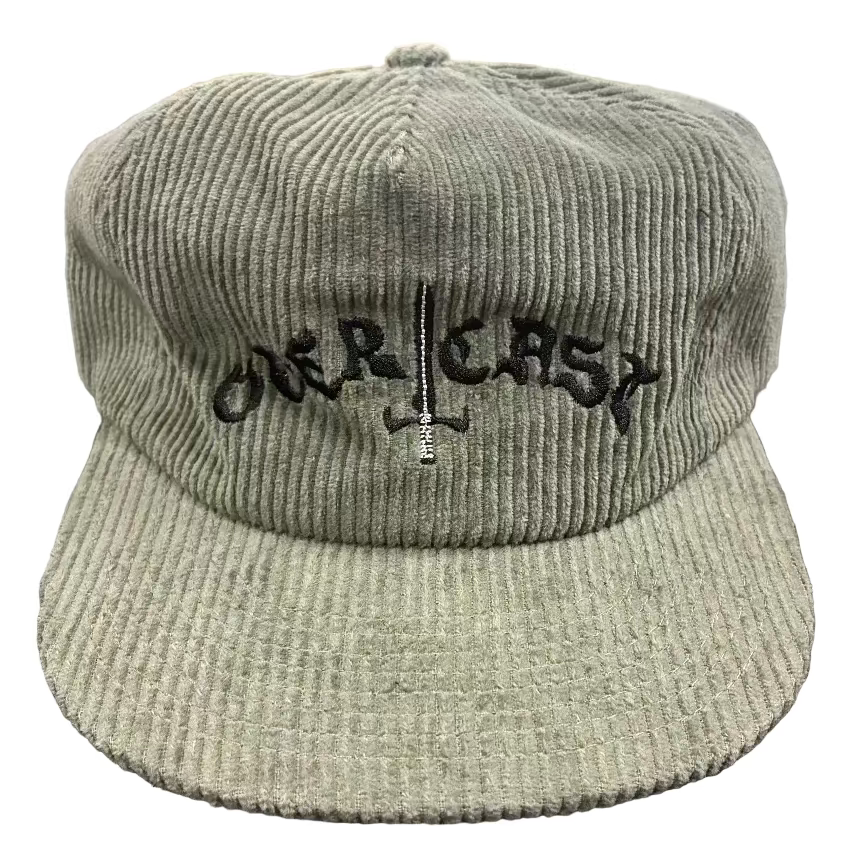 Green corduroy cap with 'ORCASA' logo on a textured surface