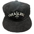 Black corduroy cap with 'OVERLORD' embroidery on a textured surface