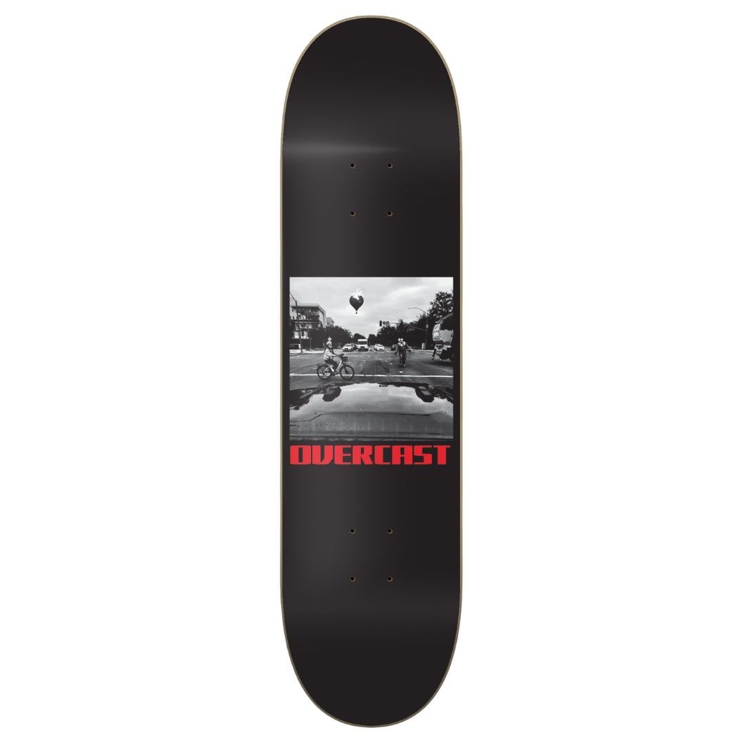 Skateboard deck with a black and white photo and 'OVERCAST' text on a white background