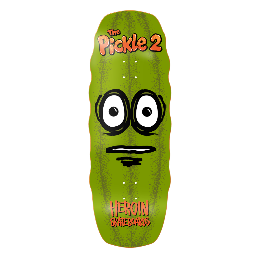 Green pickle-shaped skateboard deck with cartoon face and 'Heroin Skateboards' branding on a white background